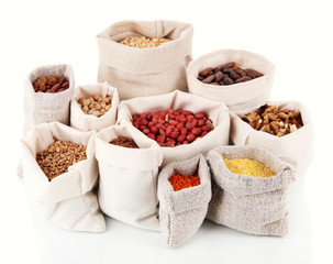 Different kinds of beans in sacks isolated on white