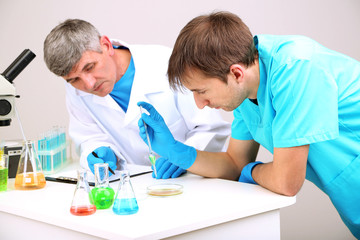 Obraz premium Physician and assayer during research on room background