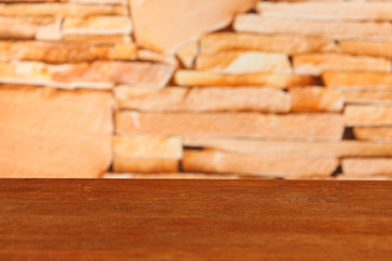 Wooden table on bricks background