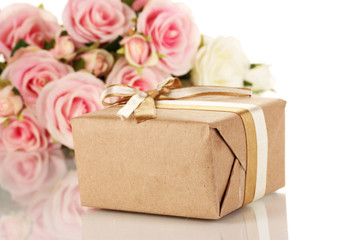 Beautiful gift on flowers background isolated on white