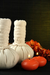 Herbal compress balls for spa treatment on bamboo background