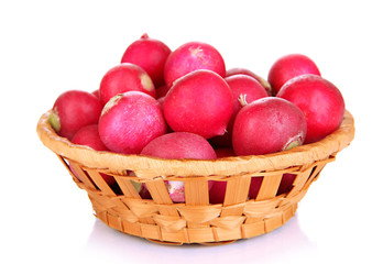 Small garden radish in wicker basket isolated on white