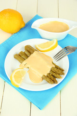 Asparagus on plate, on wooden background
