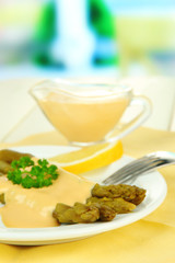Asparagus on plate, on wooden table on bright background