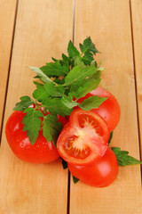 Fresh tomatoes on wooden table close-up