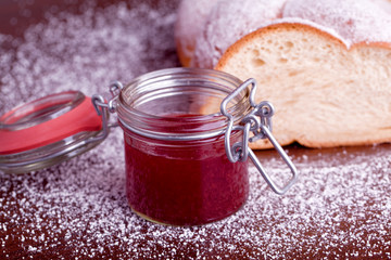 braided sweet bread with red strawberry jam