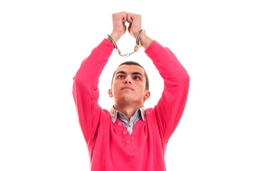 Fototapeta premium man in handcuffs, looking at his hands with regret and remorse