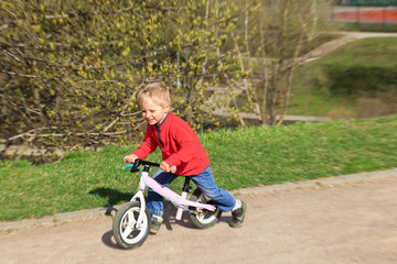 little boy riding runbike