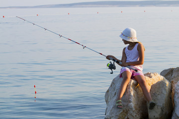 Fishing - lovely girl fishing on the beach