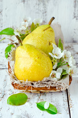 Fresh pears on the wooden background