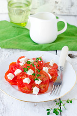 Salad from fresh tomatoes and cheese Fett with thyme