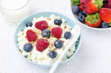 bowl of cottage cheese with berries, honey and nuts