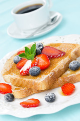 crispy toast with honey, fresh strawberries, blueberries