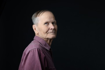 senior  looking at camera on black background