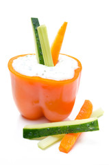 yoghurt sauce with herbs in half of pepper with vegetables