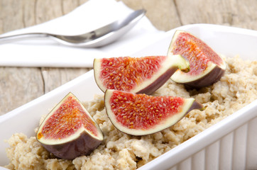 porridge with fig in a white bowl