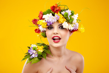 Fototapeta premium The attractive girl, front portrait, on a head a flower wreath