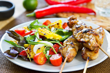 Grilled chicken skewer with salad