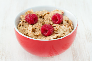 flakes with fresh berries in red bowl