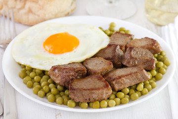 fried meat with egg and peas