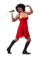 Man in female clothing singing with mic
