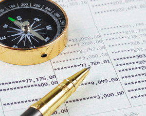 Pen and compass on bank account book