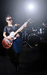 Fototapeta na wymiar Woman guitar player during concert