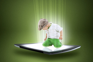 Little boy on a tablet with beams of data
