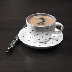 coffee cup and  e-cigarette on table
