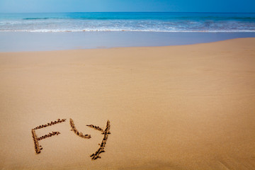 Word Fly Written in Sand on Tropical Beach