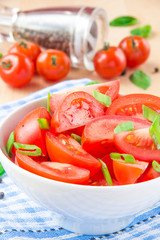 Salad from fresh tomatoes, spring green onions and black pepper