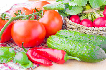 Fresh spring vegetables for salad: tomatoes, cucumbers and radis