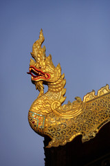 Fototapeta na wymiar Thai golden dragon on a background of blue sky