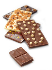 Various chocolate bars on white background