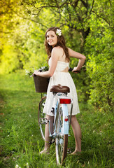 Fototapeta na wymiar Young woman with bike