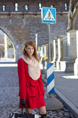 young redhaired woman crossing the street