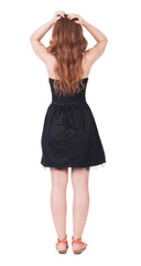 Back view of shocked  redhead woman