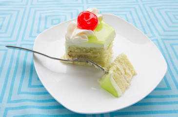 vanilla cake slice and fresh cherry