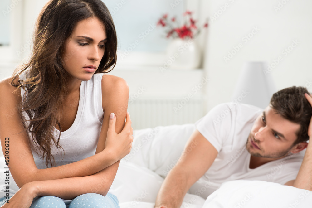 Wall mural unhappy young couple in bedroom