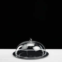 silver tray with glass cover on black background
