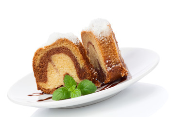 Vanilla and chocolate cake with mint laves  isolated on white