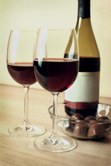 two glasses of red wine and chocolates