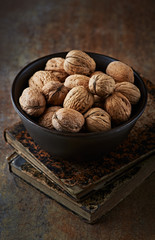 Still life with walnuts in a ceramic bowl