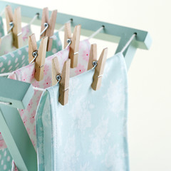Closeup of laundry drying on wooden drying rack