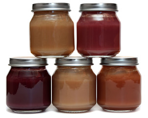 five jars of baby food and spoon