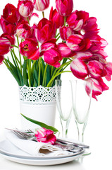 table setting with pink tulips and vintage wine glasses