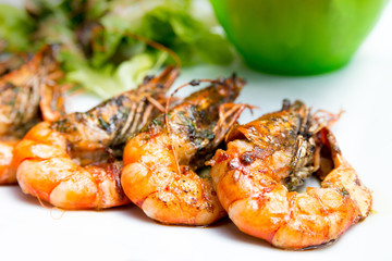 delicious fried shrimp with salad in white plate.