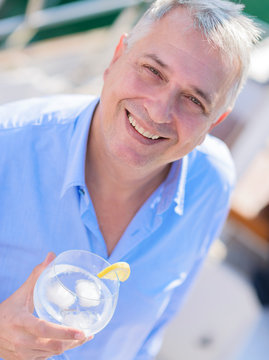 Mature Man enjoying fresh lemonade