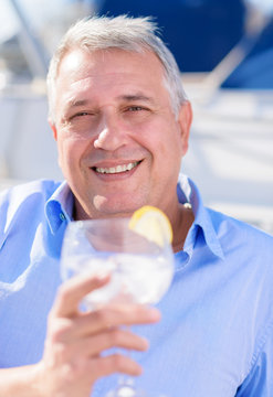 Mature Man enjoying fresh lemonade