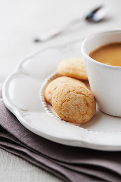 Cup of espresso with biscotti (focus on biscotti)